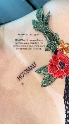 the back of a woman's shoulder with an embroidered flower and leaves on it