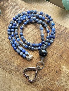 18" Beaded Lanyard features an AAA Black Agate focal bead, Sodalite, Jade and Czech glass beads with a heart shaped clasp.  🔮🔮 Each stone was selected for the ability to assist with Bonding, Trust, Manifestation and Awakening. 🔮🔮 🌼Lanyard has a Toggle clasp closure and lobster clasp for your keys and badge.  🌼  Your order will be carefully packaged to ensure that it gets you in excellent condition and I'll include a plastic badge holder and a freebies while my supplies last. 🌼  After your order is shipped (usually next day), I will send you the tracking number so you know when to expect your order. 🌼  Gemstones are known to hold many unique qualities. For more information on the healing powers of gemstones, take a look at my favorite website (not a paid promotion or affiliation,  I Everyday Beaded Necklaces With Round Beads, Blue Beaded Jewelry For Everyday Use, Everyday Blue Beaded Jewelry, Blue Round Beads Jewelry For Everyday, Trust Manifestation, Mystic Ct, Paid Promotion, Beaded Lanyard, Crystals Healing Properties