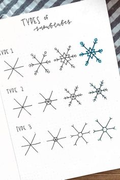 some type of snowflakes drawn on a piece of paper with marker pens in it