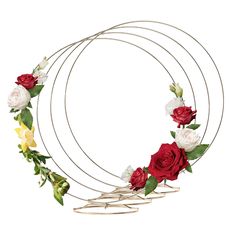 three circular metal wreaths with roses and leaves on each one, all arranged in the same circle