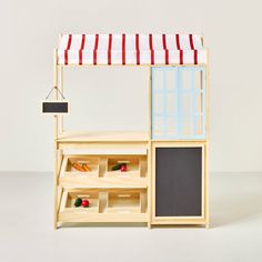 a doll house made out of wood and painted with red, white and blue stripes