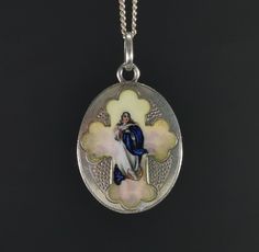 A genuine vintage Blessed Virgin Mary medal, antique enamel Catholic charm, petite religious catholic holy charm with inscription in German, very nicely done, in good vintage condition, ideal for necklace, would make a nice gift for someone special! Floats from a 16 inch long vintage 925 silver chain! Material: solid silver, porcelain Weight: 3.4g Measures: approx. 25 x 17 mm (1 x 0.6 inch) PLEASE LOOK AT THE PICTURES, THEY ARE PART OF THE DESCRIPTION AND ARE THE ACTUAL ITEM YOU WILL RECEIVE. AL Antique Enamel Necklace With Hallmark, Antique Enamel Necklace Hallmarked, Antique Enamel Hallmarked Necklaces, Antique Engraved Enamel Necklace, Antique Oval Enamel Necklaces, Antique Oval Enamel Necklace, Vintage Enamel Oval Pendant Jewelry, Vintage Enamel Jewelry For Collectors, Vintage Enamel Collectible Jewelry