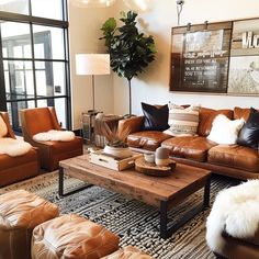 a living room filled with lots of brown furniture and pillows on top of a rug