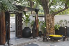 an outdoor area with potted plants and decorative items