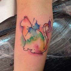 a watercolor cat tattoo on the arm