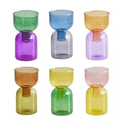 six different colored glass vases sitting side by side