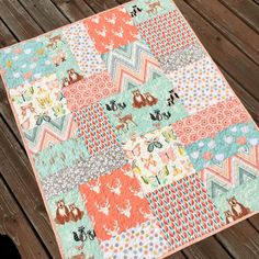 a colorful patchwork quilt on a wooden deck