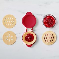 four cookie cutters with different shapes and designs on them, one has jelly in it