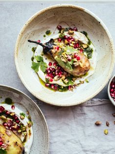 two bowls filled with food on top of a table