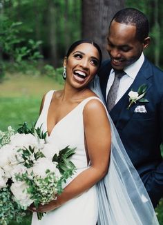 a bride and groom smile as they pose for the camera