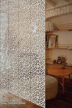 the room divider is made out of wood and has an intricate pattern on it