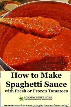 spaghetti sauce for canning with fresh tomatoes in a large metal pan on top of a stove