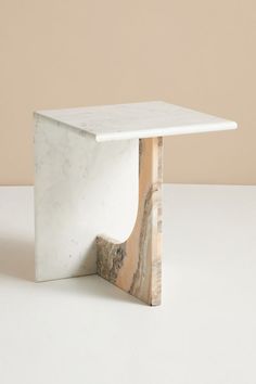 a white table with a marble base on the top and an open section at the bottom