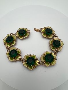 "Vintage emerald green rhinestone enamel flower link bracelet  In good condition with some minor wear Measures 7.5\" 2023" Green Emerald Jewelry In Flower Shape, Green Emerald Flower-shaped Jewelry, Green Emerald Flower Jewelry, Green Flower-shaped Formal Jewelry, Green Flower-shaped Emerald Jewelry, Green Metal Flower Jewelry, Green Metal Flower-shaped Jewelry, Green Flower-shaped Enamel Jewelry, Green Metal Bracelet Costume Jewelry