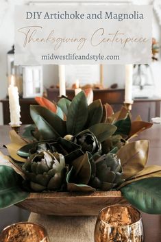 thanksgiving centerpiece with candles and succulents on the table in front of it