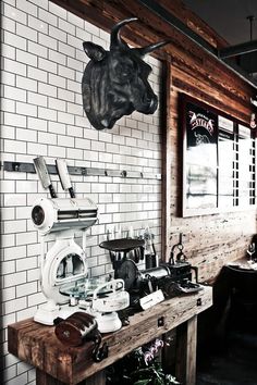 a coffee shop with an animal's head hanging above the counter and other items on display