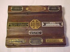 an old wooden case with several different types of labels on the front and back of it