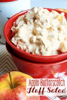 an apple butterscotch fluff salad in a red bowl next to two apples