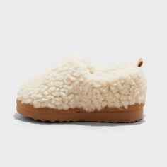 Keep your toddler's feet comfy and cozy with these Faux-Shearling Clog Slippers from Cat & Jack™. Designed in a soft beige hue, these slippers are made from plush faux-shearling fabric with a cushioned footbed for all-day comfort. A closed-toe upper with a covered back, slip-on style with a back pull tab and an indoor/outdoor outsole for all-purpose wear complete the design. Cat & Jack™: Designed for all children so you can trust it's made for yours. Cozy Closed Toe Slippers With Plush Lining, Soft Cream Round Toe Slippers, Cream Colored Comfy Slippers With Soft Detailing, Comfy Cream Slippers With Soft Detail, Comfy Soft Cream Slippers, Comfy Cream Soft Slippers, Cream Soft Comfy Slippers, Cozy Super Soft Beige Slippers, Cozy Beige Round Toe Slippers