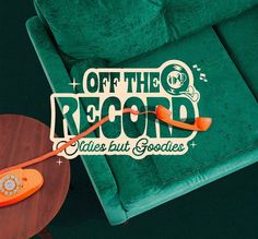 an orange phone sitting on top of a wooden table next to a green chair with the words off the record written above it