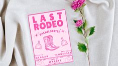 a pink t - shirt with the words last rodeo on it next to a flower