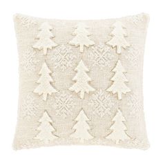 a white pillow with pine trees on the front and back, made out of knitted fabric