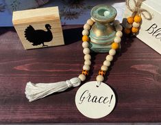 a table topped with a wooden box and a necklace next to a small bird figurine