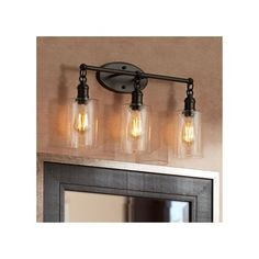 three light bathroom vanity fixture with clear glass jars on the front and back of it