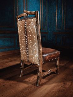 a wooden chair with deer skin on it