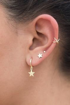 a close up of a person's ear with two stars on the side of it