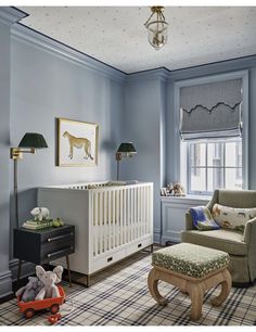 a baby's room with blue walls and furniture