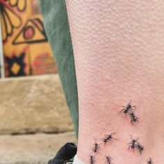 small black bugs tattoo on the ankle