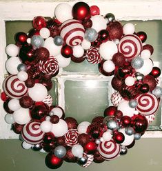 a wreath made out of red and white ornaments