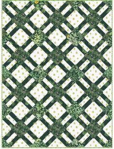 a green and white checkered quilt with flowers on the border, in front of a black background