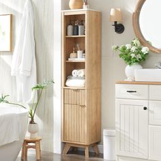 a bathroom with a wooden cabinet next to a bath tub