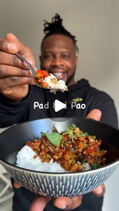 a man is holding a bowl with food in it and the words pad pao are above him