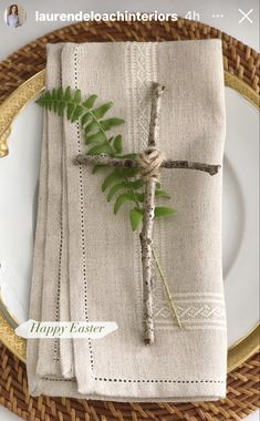 a place setting with napkins and greenery