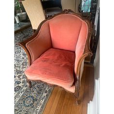 an orange chair sitting on top of a wooden floor