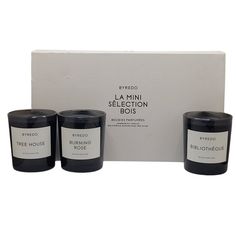 three candles in front of a white box with the words la mini selection bois on it