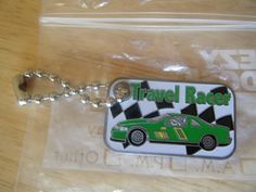 a keychain with a green car on it sitting on top of a table