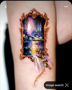 a woman's arm with a painting on it and an image in the frame