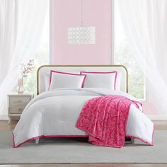 a pink and white bedroom with a chandelier