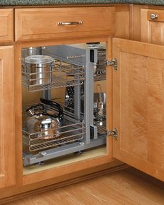 an open dishwasher in a kitchen with wooden cabinets