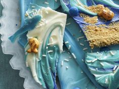 a blue and white cake with sprinkles on it