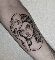 a woman's face with two faces on her arm