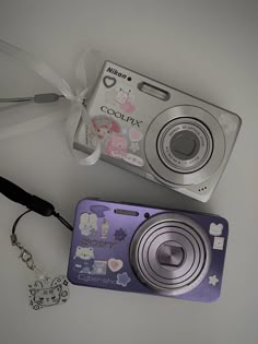 a camera and keychain are laying next to each other