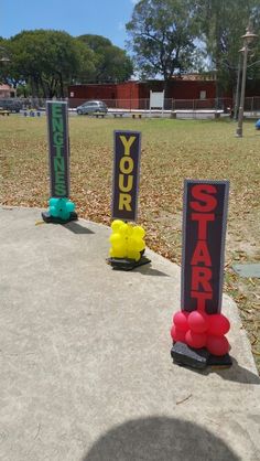 three skateboarders are lined up in front of some yard signs that say your start