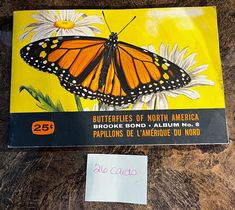 a butterfly is sitting on top of a card that says butterflies of north america, brochure rond - alum no 8 papillons de l'emboise d'ambre du monde du monon du nord