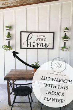 a wooden table with a sign above it that says, let's stay home add warmth