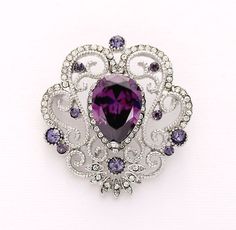 Beautiful shiny silver plated Vintage style brooch accented with dazzling purple crystal stones, can be used for your DIY project - wedding bridal bouquet, lapel corsage, blazer breastpin, clutch and hat sparkly clip, ring pillow and frame decorations, crafts, scrap booking, jewelry gift and much more! Size: 1 5/8 inch high 1 1/2 inches wide Metal: Silver plated This purple rhinestone brooch can be ordered as a flat back embellishment for your sew-on, glue-on DIY project or with a pin in the back to add to party gown or dress sash, to wire into brooch bouquet, or any number of other craft project. More PURPLE brooches - https://www.etsy.com/shop/Crystalitzy?section_id=16136519&ref=shopsection_leftnav_5 Please check for my items in my Shop - https://www.etsy.com/shop/Crystalitzy Please note Vintage Victorian Wedding, Purple Brooch, Gothic Jewelry Diy, Vintage Bouquet Wedding, Vintage Jewelry Diy, Bridal Brooch, Brooch Corsage, Crystal Purple, Bridal Brooch Bouquet